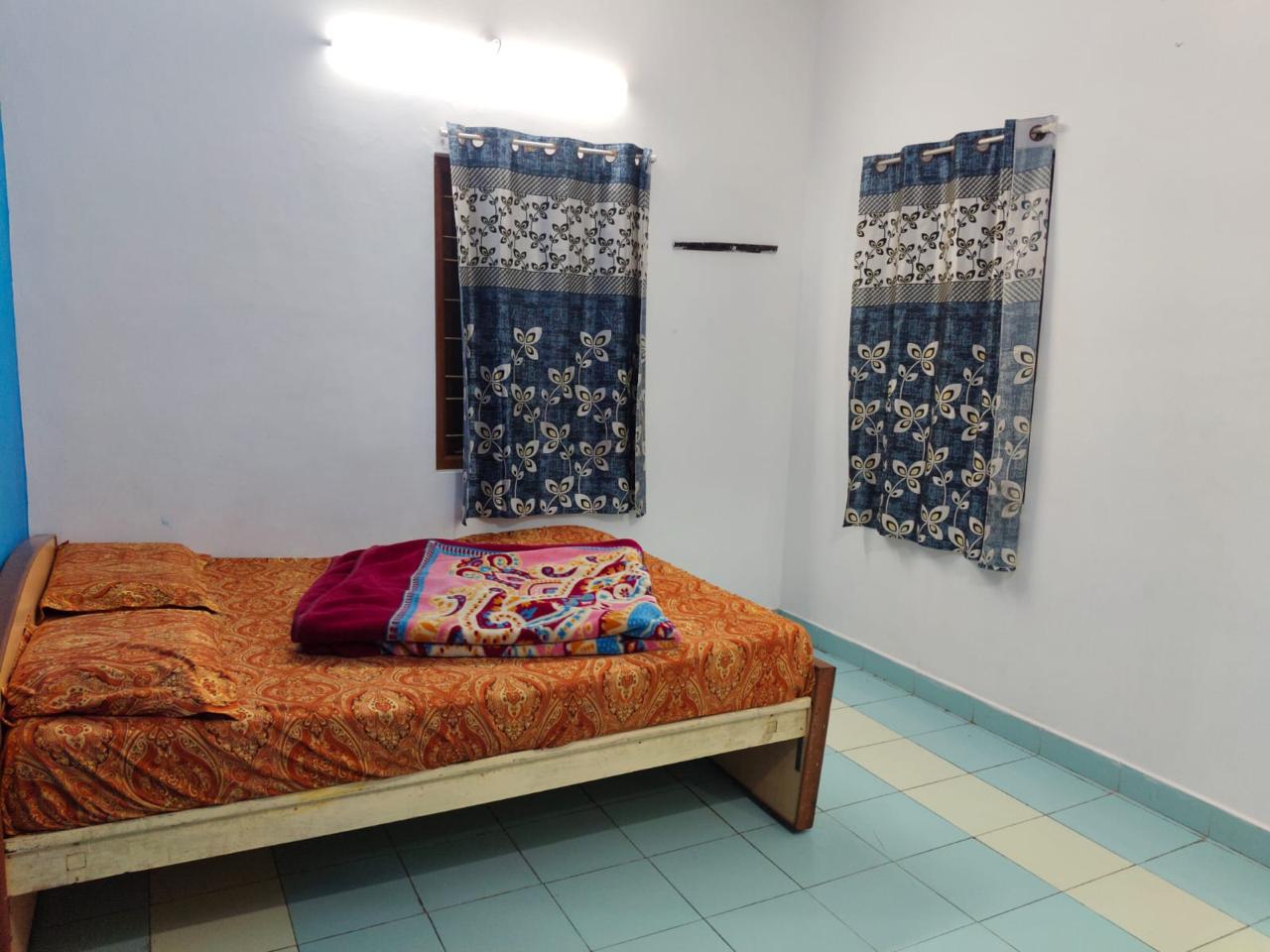 3BHK suite bedroom with orange accent